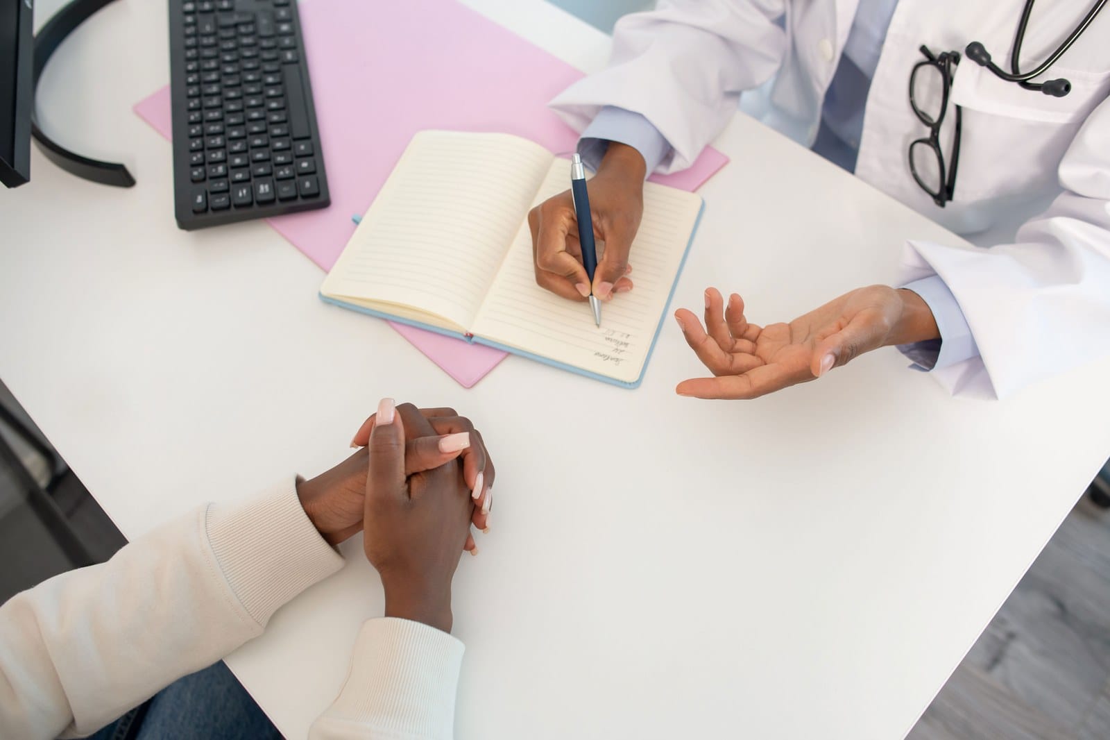 Doctor at desk speaking with patient during consultation for cervical cancer radiation therapy walkthrough